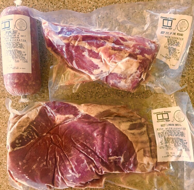Two individual packages of frozen Connolly Ranch beef.