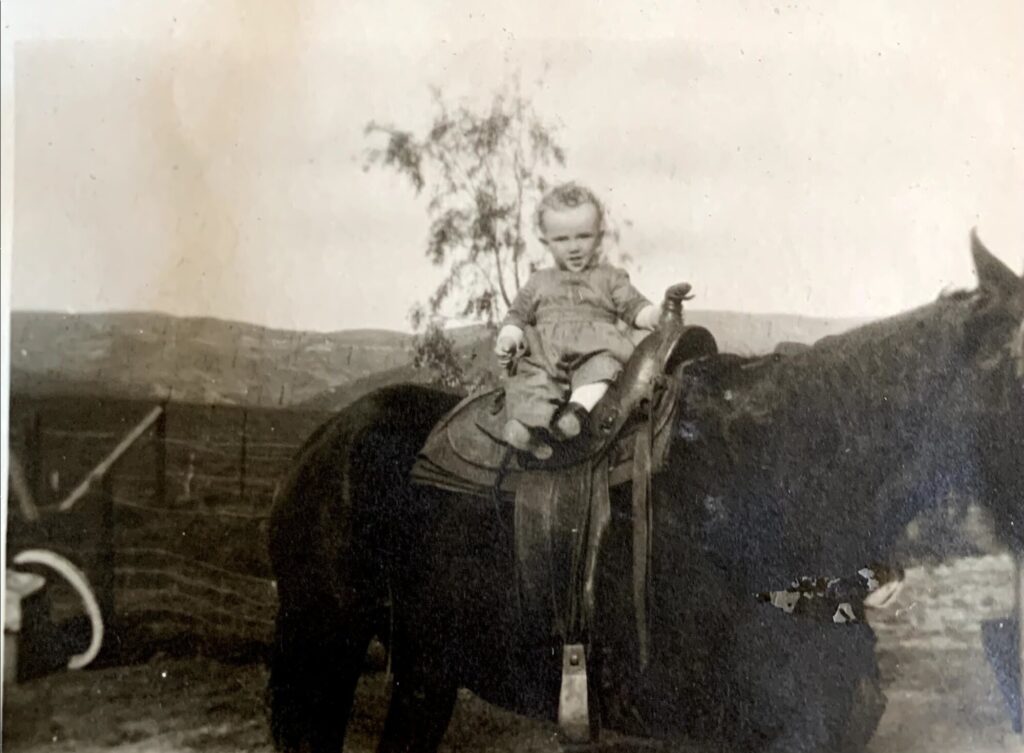Sepia historic photo of baby Robert Connolly (3d generation) on a horse circa 1922. 
