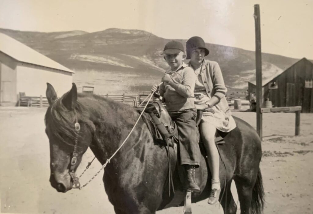 Sepia historic photograph of young Robert Connolly (3d generation) on horse on the ranch with older girl circa 1930. 